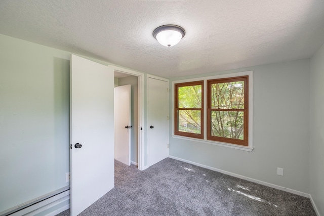 6730 NW Timberline Dr, Des Moines, IA 50313 - unfurnished bedroom featuring a textured ceiling and carpet floors