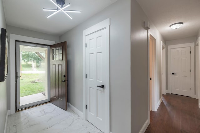 6730 NW Timberline Dr, Des Moines, IA 50313 - foyer entrance with baseboards and light marble finish flooring