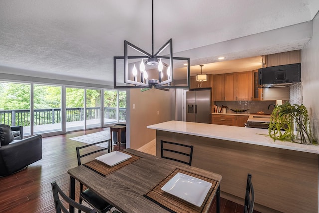 6730 NW Timberline Dr, Des Moines, IA 50313 - dining room with a chandelier, wood finished floors, and recessed lighting