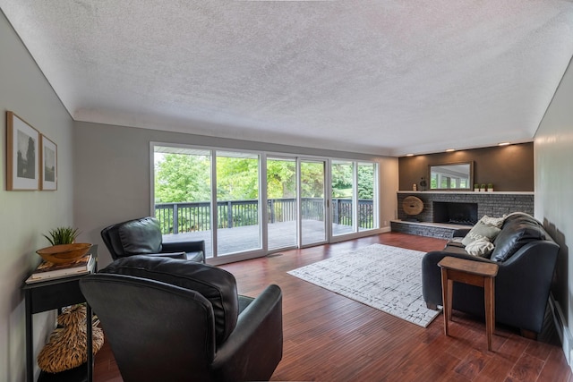 6730 NW Timberline Dr, Des Moines, IA 50313 - living area featuring a textured ceiling, wood finished floors, and a fireplace