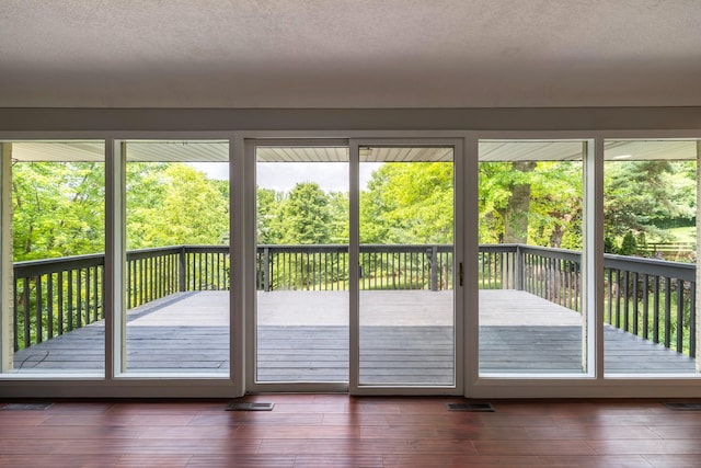 6730 NW Timberline Dr, Des Moines, IA 50313 - doorway featuring healthy amount of natural light, dark wood-style floors, and a textured ceiling