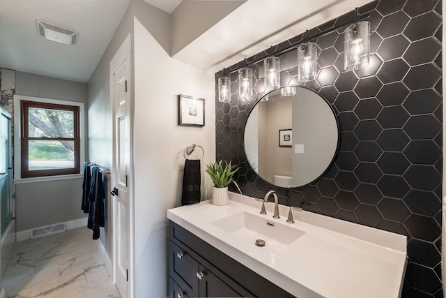 6730 NW Timberline Dr, Des Moines, IA 50313 - full bathroom featuring vanity, marble look tile flooring, and a shower with shower door