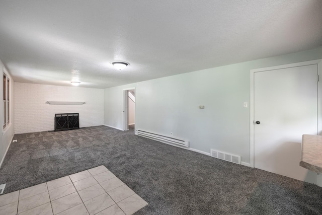 6730 NW Timberline Dr, Des Moines, IA 50313 - unfurnished living room featuring baseboard heating, carpet flooring, a brick fireplace, a textured ceiling, and tile patterned floors