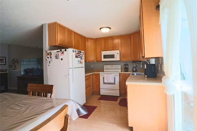 204 25th Ave SW, Altoona, IA 50009 - kitchen featuring white appliances, light countertops, and brown cabinetry