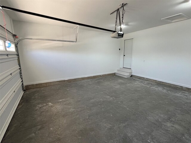 711 W N Ave, Norwalk, IA 50211 - garage with a garage door opener and baseboards