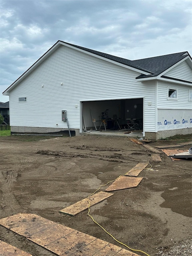 711 W N Ave, Norwalk, IA 50211 - view of home's exterior featuring driveway, a garage, and roof with shingles