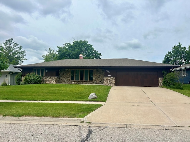 2907 Northwood Dr, Ames, IA 50010 - ranch-style house featuring stone siding, a garage, concrete driveway, a front lawn, and a chimney