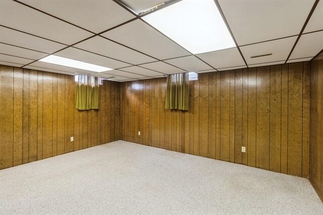 2907 Northwood Dr, Ames, IA 50010 - finished below grade area with a drop ceiling, carpet floors, and wood walls