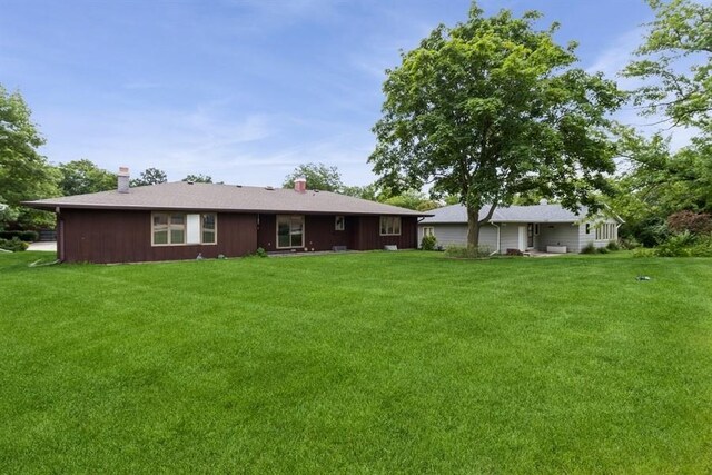 2907 Northwood Dr, Ames, IA 50010 - rear view of property with a yard and a chimney