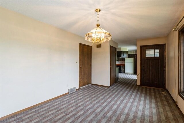 2907 Northwood Dr, Ames, IA 50010 - empty room with carpet floors and a chandelier