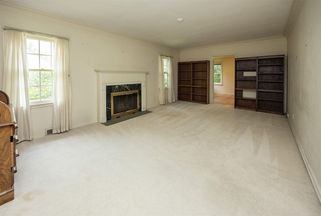 5800 Pleasant Dr, Des Moines, IA 50312 - unfurnished living room featuring carpet flooring, a fireplace, healthy amount of natural light, and crown molding