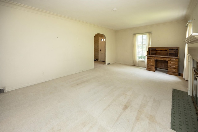 5800 Pleasant Dr, Des Moines, IA 50312 - unfurnished living room featuring arched walkways, ornamental molding, and light colored carpet