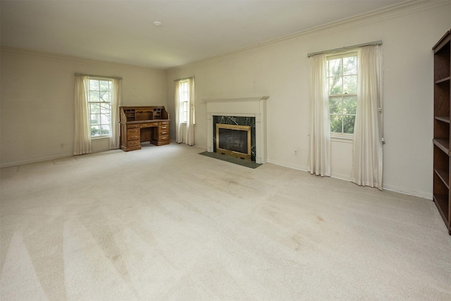 5800 Pleasant Dr, Des Moines, IA 50312 - unfurnished living room featuring a high end fireplace, ornamental molding, plenty of natural light, and carpet