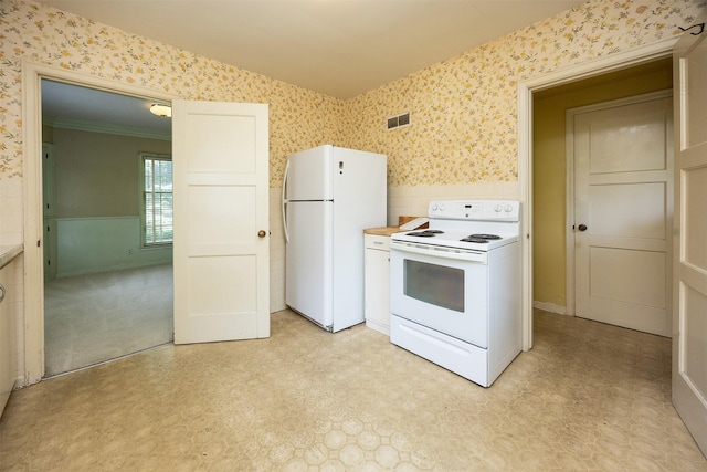 5800 Pleasant Dr, Des Moines, IA 50312 - kitchen with white appliances, wallpapered walls, a wainscoted wall, light floors, and light countertops