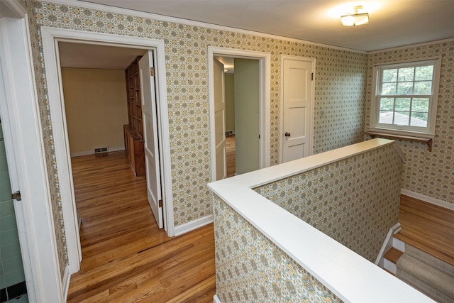 5800 Pleasant Dr, Des Moines, IA 50312 - corridor with light wood-type flooring and crown molding