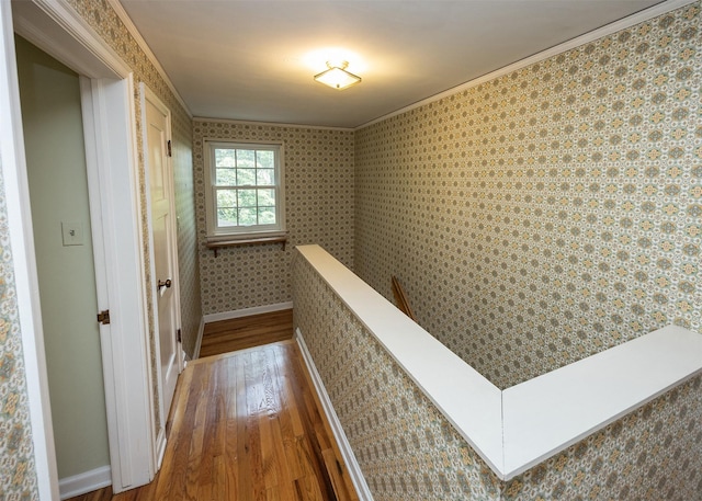 5800 Pleasant Dr, Des Moines, IA 50312 - hall with wood-type flooring, ornamental molding, and an upstairs landing