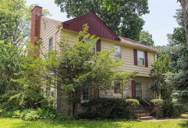 5800 Pleasant Dr, Des Moines, IA 50312 - view of front of home featuring stone siding and a chimney