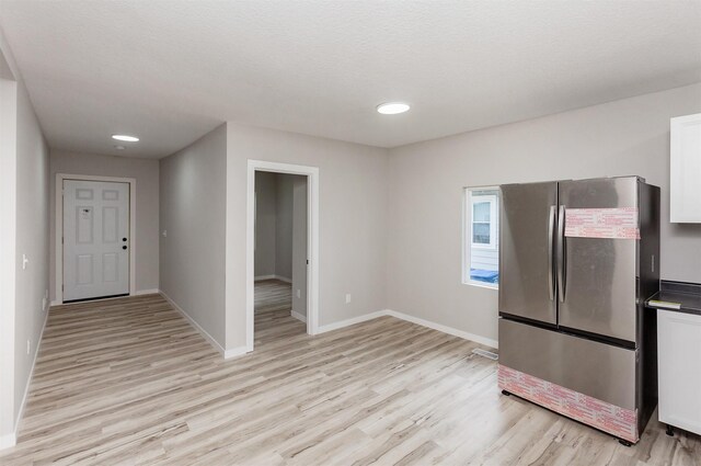 3308 Cambridge St, Des Moines, IA 50313 - kitchen featuring freestanding refrigerator, light wood-style floors, white cabinetry, recessed lighting, and dark countertops