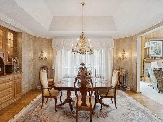 501 S 33rd St, West Des Moines, IA 50265 - dining room featuring a tray ceiling, a chandelier, light wood-style floors, and wallpapered walls