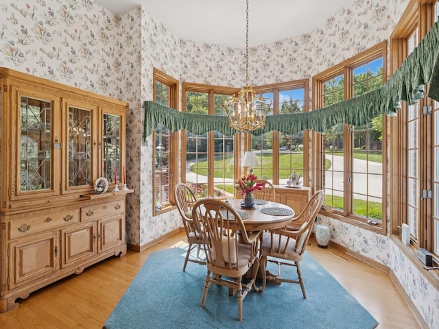 501 S 33rd St, West Des Moines, IA 50265 - dining area featuring wallpapered walls, a chandelier, light wood-style flooring, and healthy amount of natural light