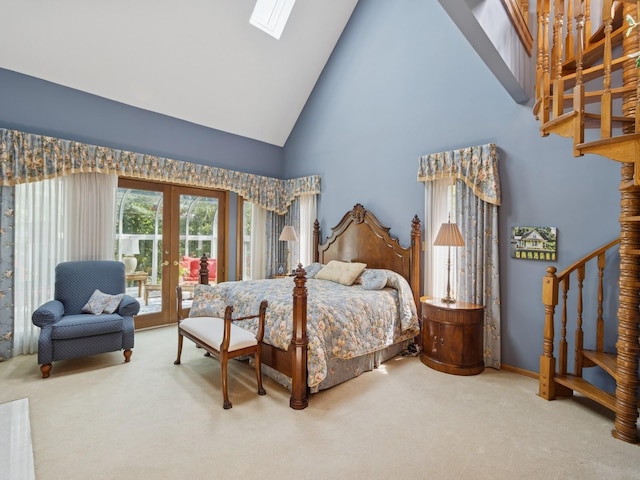 501 S 33rd St, West Des Moines, IA 50265 - carpeted bedroom featuring french doors, high vaulted ceiling, a skylight, and access to exterior