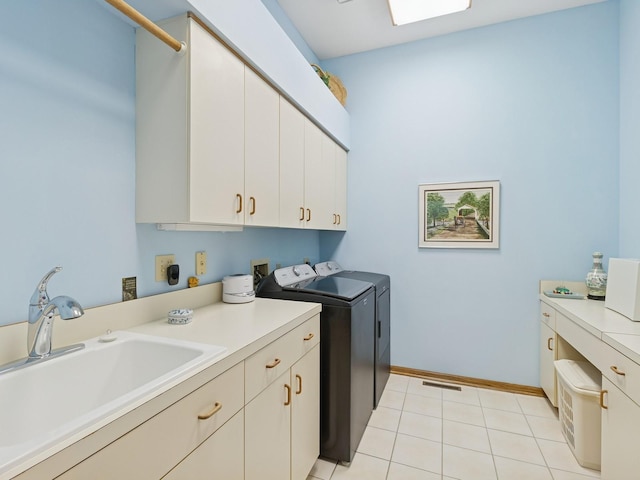 501 S 33rd St, West Des Moines, IA 50265 - washroom featuring cabinet space, washing machine and clothes dryer, and light tile patterned floors