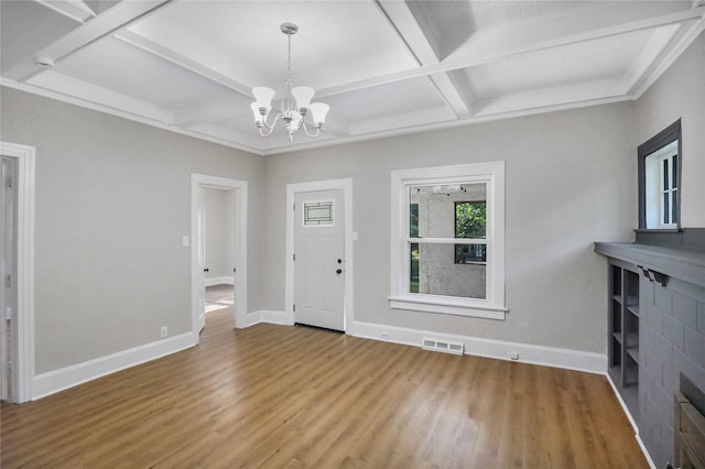 1418 33rd St, Des Moines, IA 50311 - entrance foyer with coffered ceiling, wood finished floors, a chandelier, beam ceiling, and a fireplace