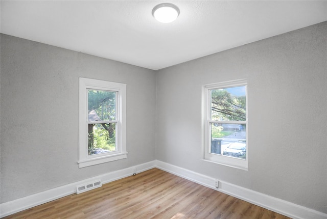 1418 33rd St, Des Moines, IA 50311 - unfurnished room featuring plenty of natural light and light wood finished floors