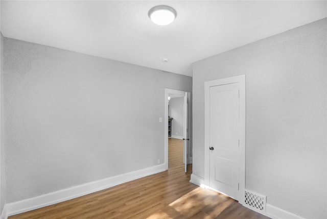 1418 33rd St, Des Moines, IA 50311 - unfurnished room with wood finished floors and baseboards