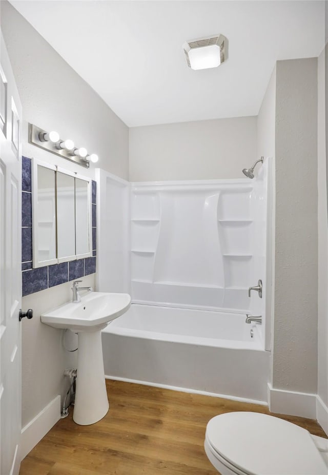 1418 33rd St, Des Moines, IA 50311 - full bathroom featuring bathing tub / shower combination and wood finished floors