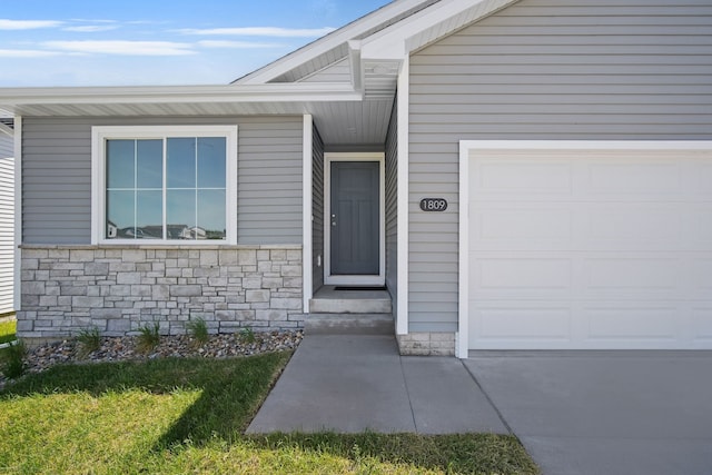 4270 Grover Woods Ln, Des Moines, IA 50317 - doorway to property with a garage and stone siding