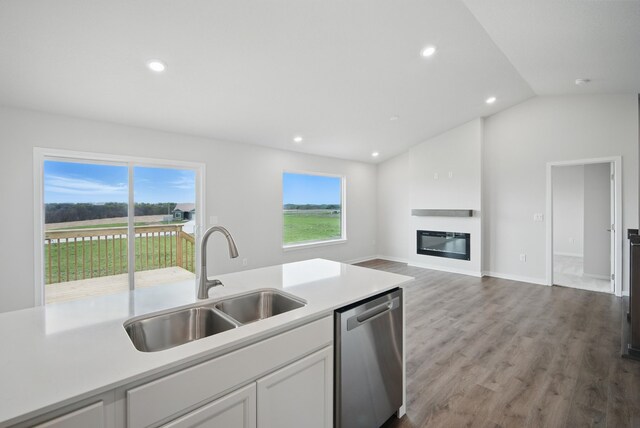4270 Grover Woods Ln, Des Moines, IA 50317 - kitchen with stainless steel dishwasher, white cabinetry, light countertops, wood finished floors, and recessed lighting