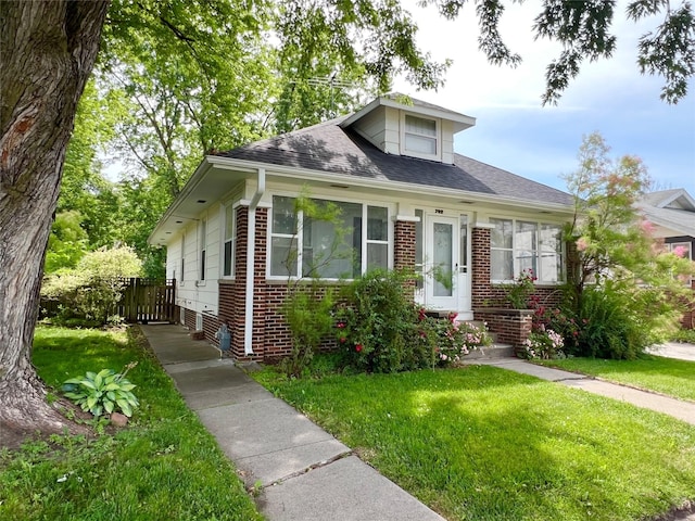 702 W 6th St S, Newton, IA 50208 - bungalow-style home featuring brick siding and a shingled roof