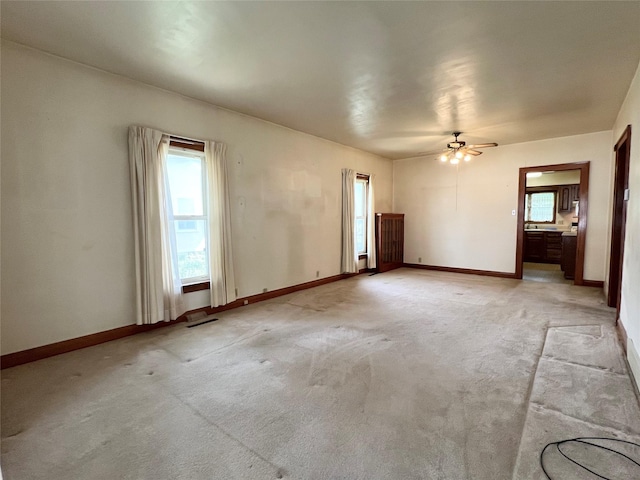 702 W 6th St S, Newton, IA 50208 - empty room featuring a ceiling fan and light carpet