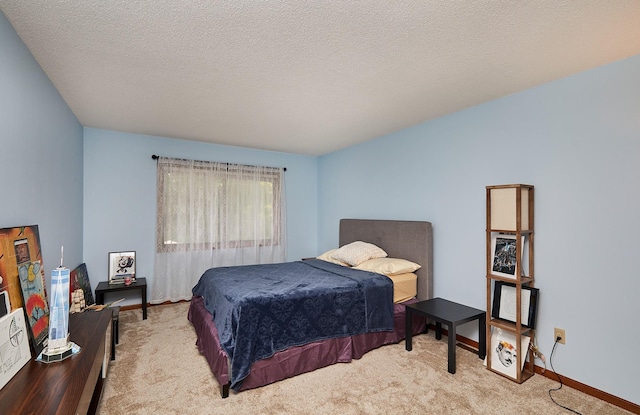 4718 71st St, Urbandale, IA 50322 - carpeted bedroom with baseboards and a textured ceiling