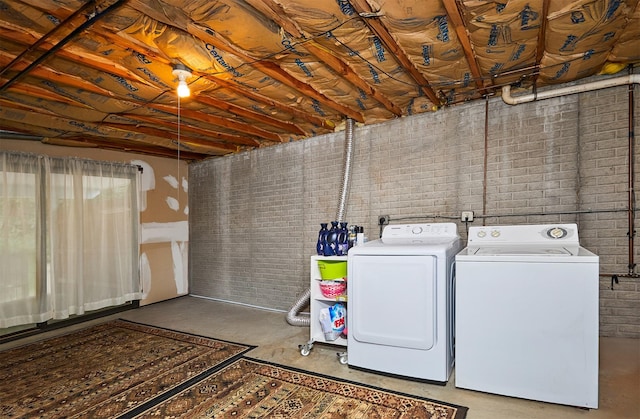 4718 71st St, Urbandale, IA 50322 - laundry area with washer and dryer and brick wall