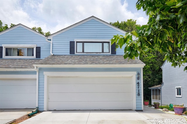 4718 71st St, Urbandale, IA 50322 - view of front of property featuring driveway and a garage