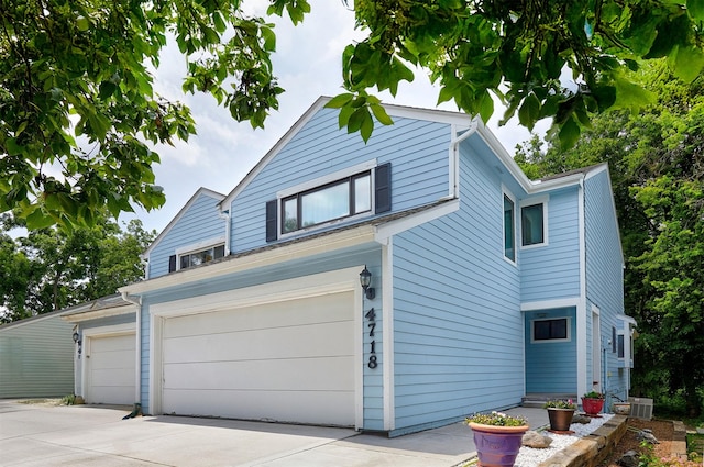 4718 71st St, Urbandale, IA 50322 - view of home's exterior with driveway and an attached garage