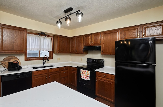 4718 71st St, Urbandale, IA 50322 - kitchen featuring black appliances, under cabinet range hood, tasteful backsplash, a textured ceiling, and light stone counters