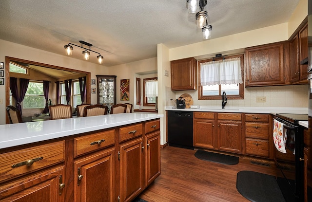 4718 71st St, Urbandale, IA 50322 - kitchen featuring black appliances, dark wood-type flooring, light countertops, a textured ceiling, and tasteful backsplash