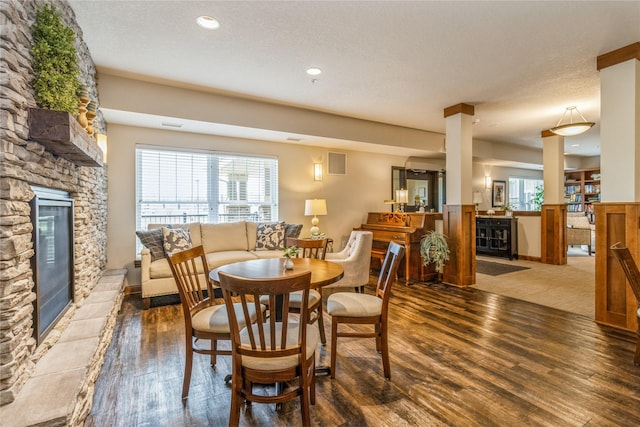 1250 SW Magazine Rd Unit 215, Ankeny, IA 50023 - dining area featuring wood finished floors, a fireplace, recessed lighting, and a textured ceiling