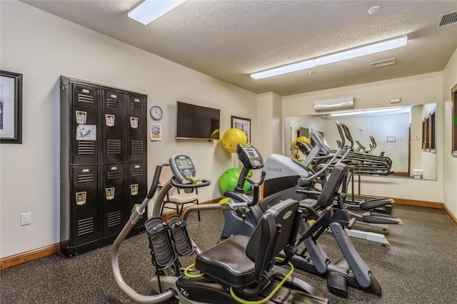 1250 SW Magazine Rd Unit 215, Ankeny, IA 50023 - workout area with a wall mounted AC and a textured ceiling