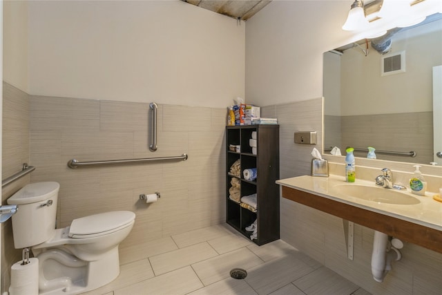 1250 SW Magazine Rd Unit 215, Ankeny, IA 50023 - bathroom with tile walls, a wainscoted wall, and tile patterned flooring