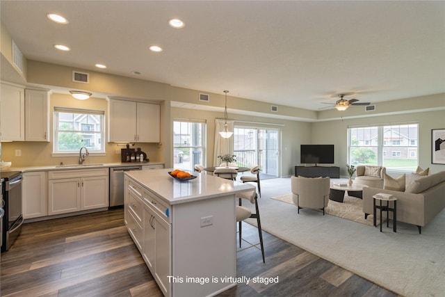 1250 SW Magazine Rd Unit 215, Ankeny, IA 50023 - kitchen featuring stainless steel appliances, open floor plan, light countertops, a kitchen breakfast bar, and recessed lighting