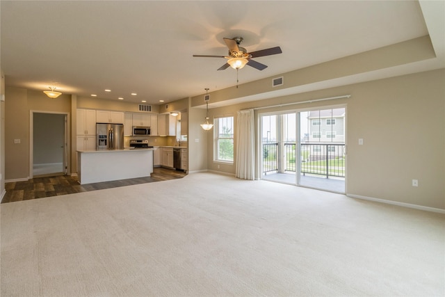 1250 SW Magazine Rd Unit 215, Ankeny, IA 50023 - unfurnished living room featuring ceiling fan, dark colored carpet, and recessed lighting