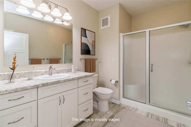 1250 SW Magazine Rd Unit 215, Ankeny, IA 50023 - full bathroom featuring a stall shower, vanity, and wood finished floors