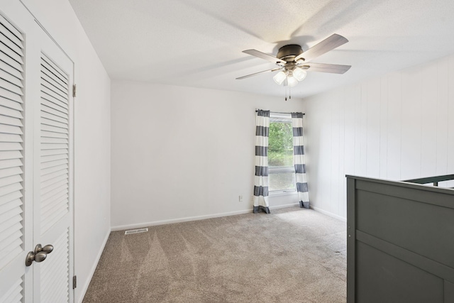 1808 80th St, Windsor Heights, IA 50324 - unfurnished bedroom featuring carpet, ceiling fan, and a closet