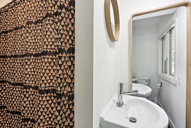 1808 80th St, Windsor Heights, IA 50324 - bathroom featuring a sink and a textured wall