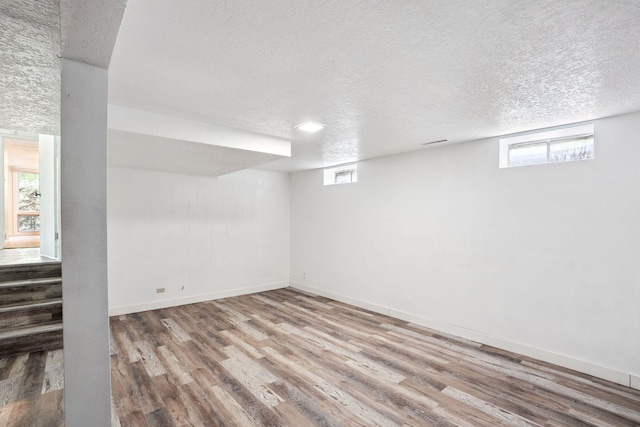 1808 80th St, Windsor Heights, IA 50324 - basement with wood finished floors, a textured ceiling, and healthy amount of natural light