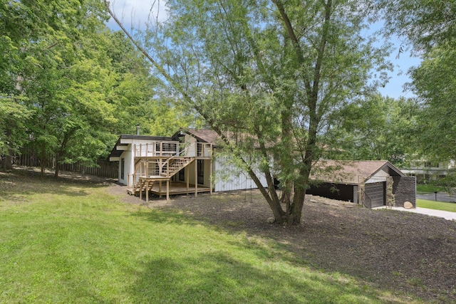 1808 80th St, Windsor Heights, IA 50324 - rear view of property with stairs, concrete driveway, a deck, and a detached garage
